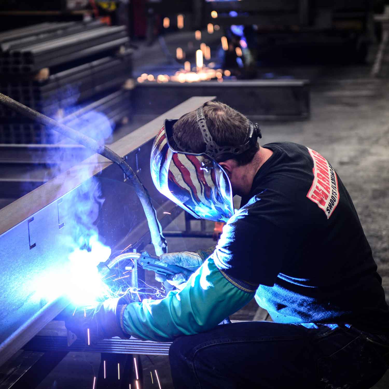 Welder works in trailer manufacturing facility