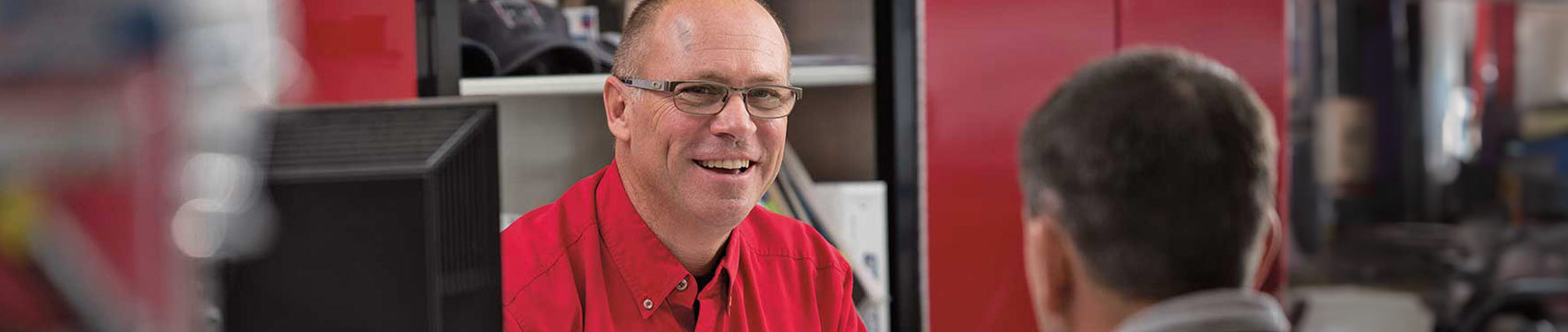 Novae employee wearing a red shirt in the office